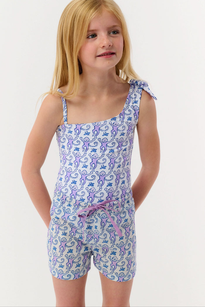 A child models the Roller Rabbit Kids Monkey Lounge Short—a matching pajama set with a blue and purple monkey print, sleeveless top, and cambric shorts with a purple drawstring—against a plain white background.