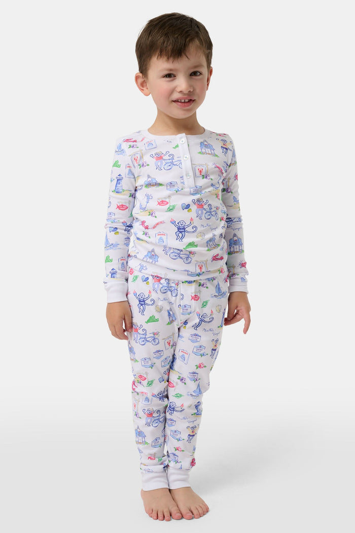 Crafted from soft Pima cotton, the Roller Rabbit Monkey On The Vineyard Long Sleeve Polo Pajamas feature a button-up long-sleeve top and long pants adorned with the playful Monkey on the Vineyard print, showcasing various animals, objects, and buildings on a plain white background.