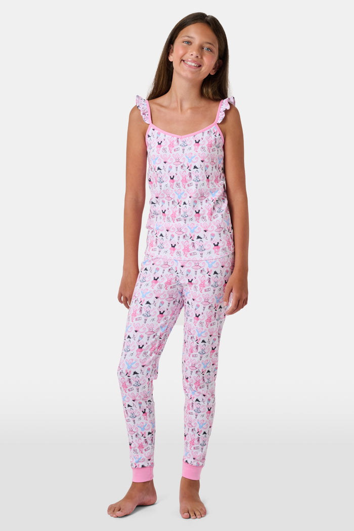 The Kids Monkey Pirouette Blaire Pajamas by Roller Rabbit is a children's pajama set crafted from soft Pima cotton, featuring a sleeveless top with ruffled straps and long pants, both in white with a playful pink, blue, and black monkey cartoon print and pink trim.