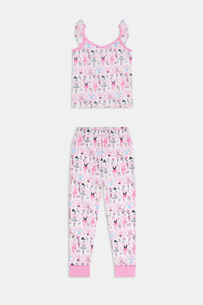 The Kids Monkey Pirouette Blaire Pajamas by Roller Rabbit is a children's pajama set crafted from soft Pima cotton, featuring a sleeveless top with ruffled straps and long pants, both in white with a playful pink, blue, and black monkey cartoon print and pink trim.