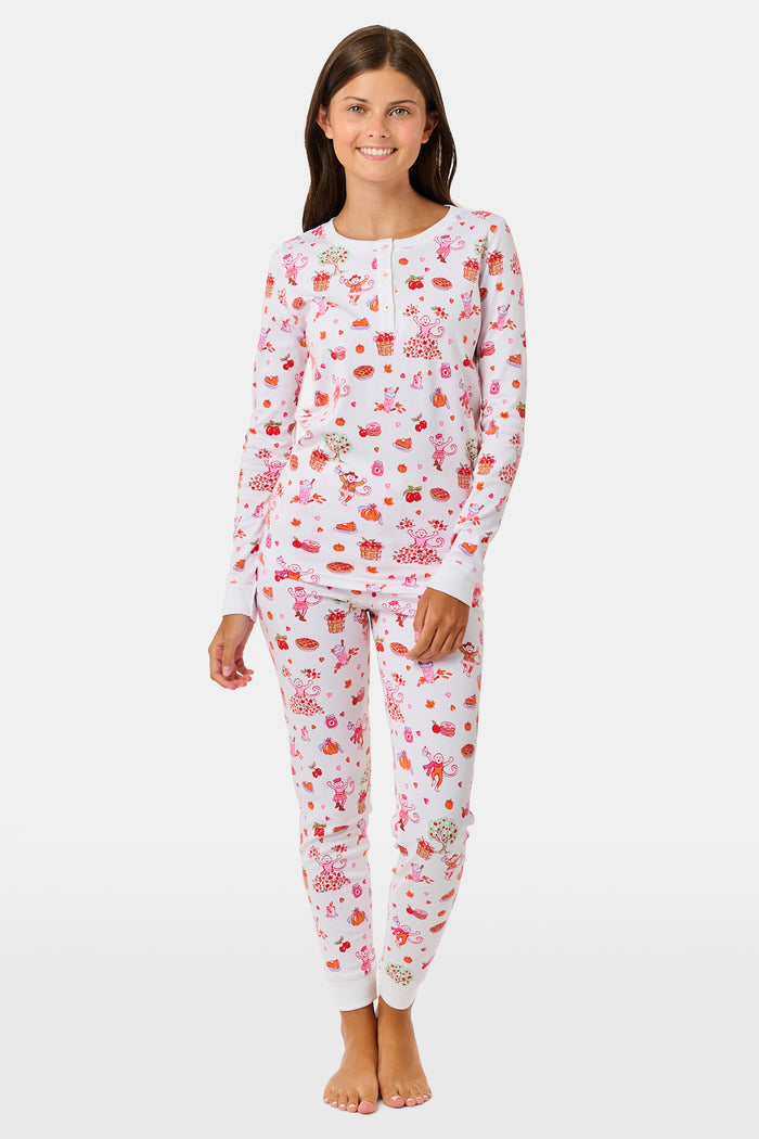 A girl wearing Roller Rabbit Kids Sweater Weather Pajamas stands barefoot, smiling, against a plain white background.