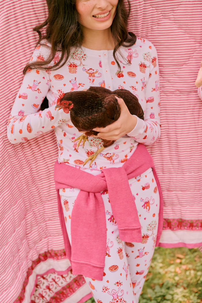 A girl wearing Roller Rabbit Kids Sweater Weather Pajamas stands barefoot, smiling, against a plain white background.