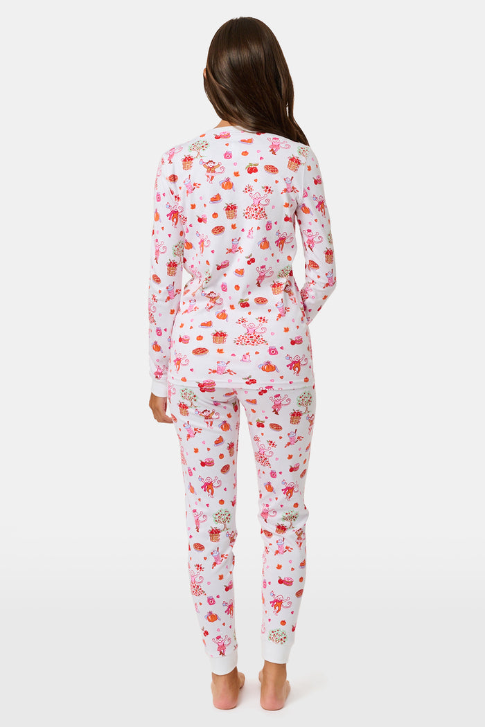 A girl wearing Roller Rabbit Kids Sweater Weather Pajamas stands barefoot, smiling, against a plain white background.