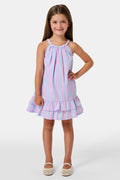A young girl wearing the Roller Rabbit Kids Sweet Stripe Casey Dress stands in front of lockers, smiling and holding a folder decorated with colorful raindrops.