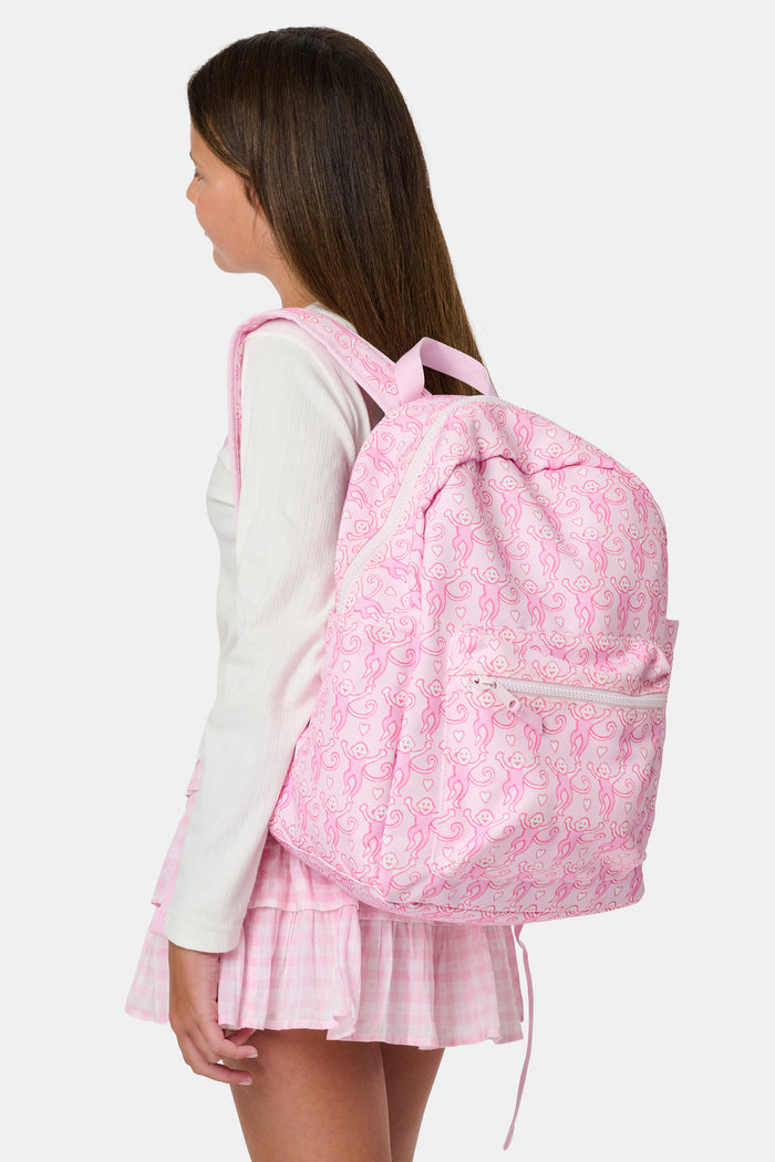 Introducing the Lovely Monkey Backpack by Roller Rabbit, showcasing a charming pattern of playful pink monkeys on a light pink background. Crafted from durable polyester, this backpack features a front zipper pocket, side pockets, and a top handle—all coordinated in matching pink hues.