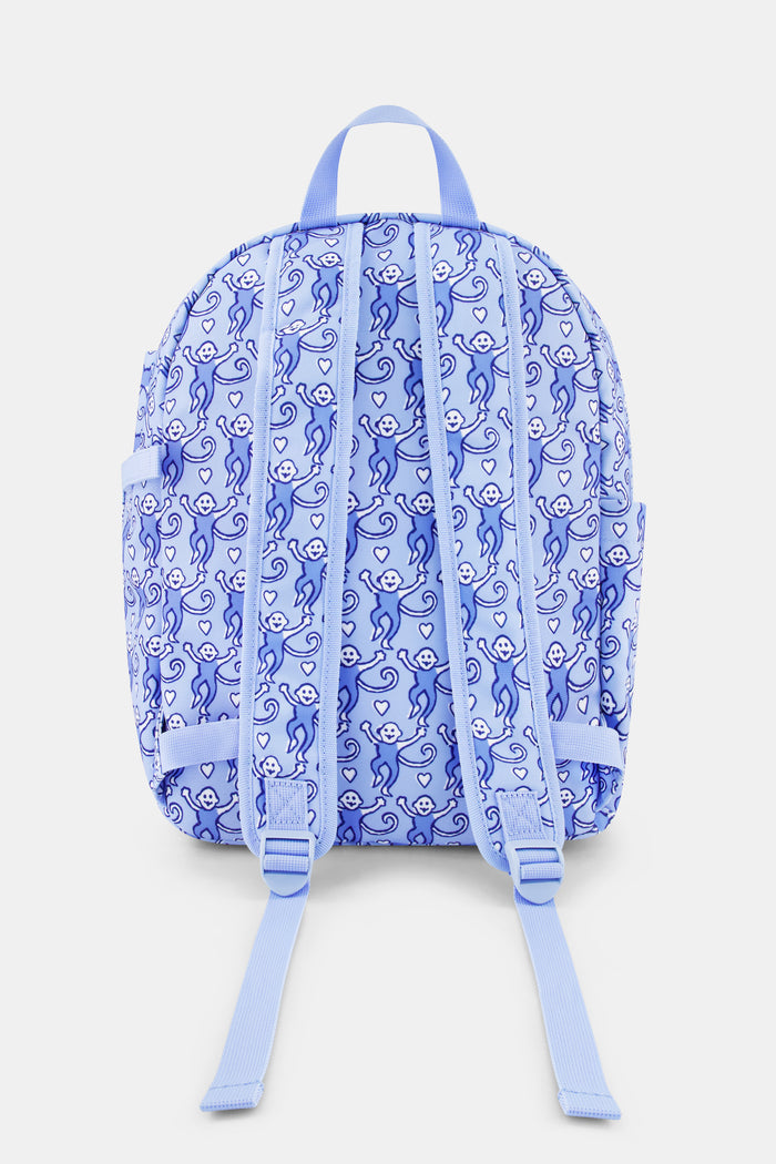 The Roller Rabbit Lovely Monkey Backpack for kids features a playful pattern of monkeys in various poses, a front pocket, and pink zippers set against a light background.