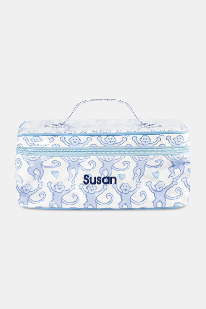 The Roller Rabbit Lovely Monkey Carry All Case is a rectangular, water-resistant cosmetic bag with a light blue zipper and handle, featuring playful blue monkeys and hearts on white—a perfect travel companion for your essentials.