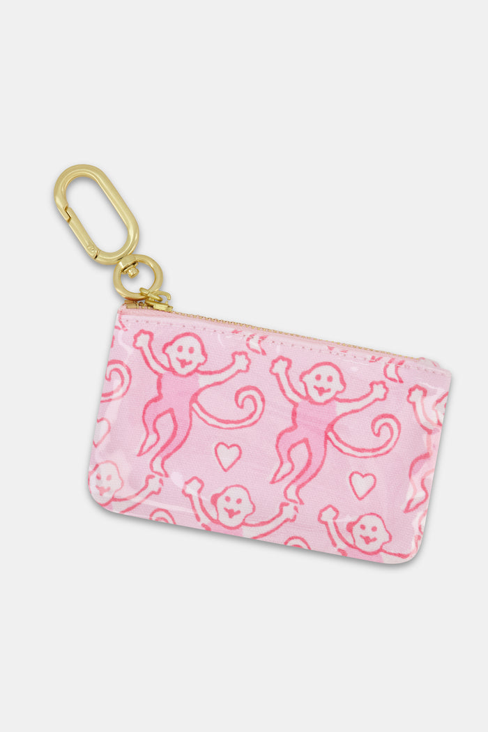 The Roller Rabbit Lovely Monkey Coin Pouch is a small pink pouch featuring a playful pattern of pink monkeys and hearts, finished with a gold clip.