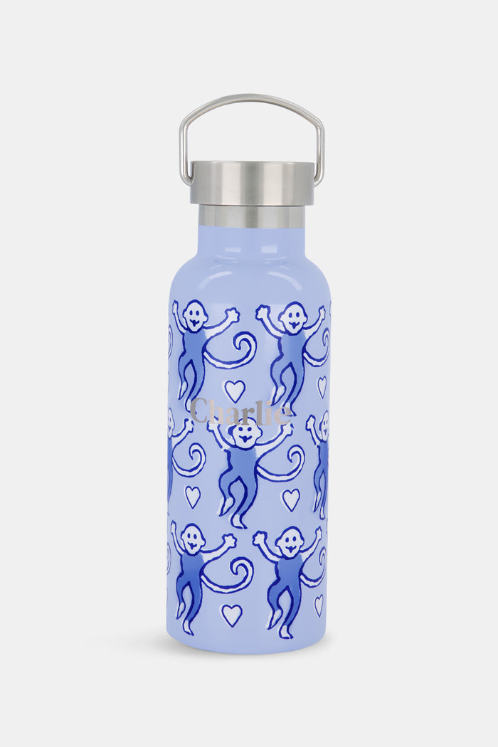 Introducing the Lovely Monkey Water Bottle from Roller Rabbit—a light blue bottle with a metal lid, adorned with a charming pattern of purple and blue cartoon monkeys and tiny white hearts. Designed to fit most cupholders, it's perfect for the gym or for on-the-go hydration.