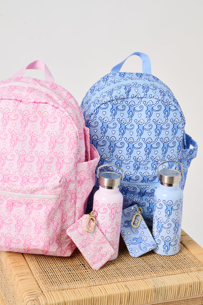 Introducing the Lovely Monkey Water Bottle by Roller Rabbit—a pink stainless steel bottle with a silver cap, featuring a charming repeating pattern of pink monkeys and hearts. Ideal for daily hydration or taking to the gym.