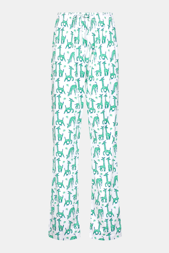 A person wears Roller Rabbit's Mens Gigi Giraffe Simon Pant, white pajama pants with a giraffe print, standing barefoot against a plain white background. Made from 100 Pima Cotton, the pull-on style features a hand in the pocket and a partially visible upper body.