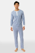 A man stands barefoot in Roller Rabbit's Mens Hathi Spencer Pajamas, a blue and white long-sleeve set with a small pattern and buttoned collar, made from 100 Pima Cotton, against a plain white background.