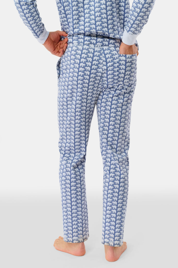 A man stands barefoot in Roller Rabbit's Mens Hathi Spencer Pajamas, a blue and white long-sleeve set with a small pattern and buttoned collar, made from 100 Pima Cotton, against a plain white background.