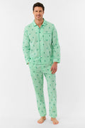 A man stands barefoot against a white background, smiling and facing forward, wearing Roller Rabbit's Mens Leo Gingham Loungewear—a light green, long-sleeved button-up set with matching pants featuring a small lion print pattern.