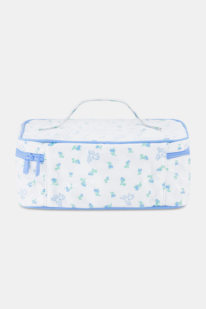 The Roller Rabbit Mini Monkey Blossom Carry All Case is a rectangular white fabric toiletry bag featuring a blue floral and monkey pattern, blue trim, a zip-around top closure, and a clear plastic handle on the lid.