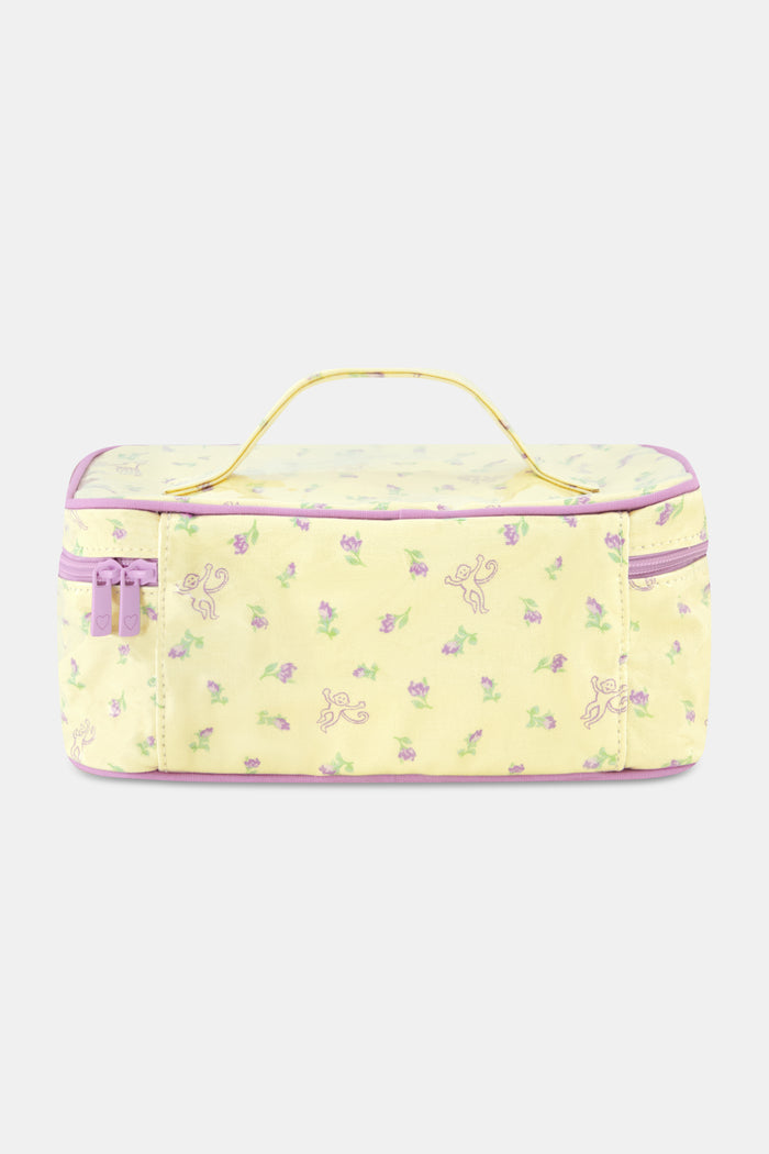 The Roller Rabbit Mini Monkey Blossom Carry All Case is a rectangular yellow toiletry bag featuring a pink floral pattern, a purple zipper, and a yellow handle on top. Displayed against a plain white background, this stylish travel bag is perfect for organizing your essentials.