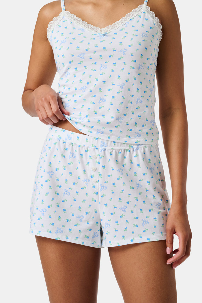 Introducing the Roller Rabbit Mini Monkey Blossom Jones Shortie, a white boxer short featuring a playful pattern of small blue and green turtles and rabbits. Crafted from soft cotton modal for a gentle feel and relaxed fit, this short is showcased against a simple light background.