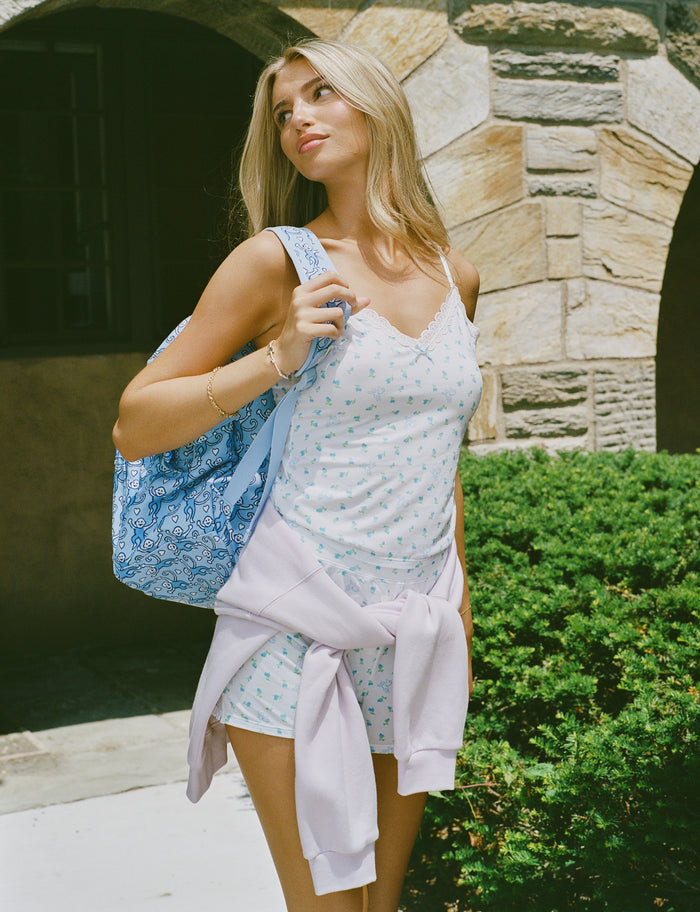 Introducing the Roller Rabbit Mini Monkey Blossom Jones Shortie, a white boxer short featuring a playful pattern of small blue and green turtles and rabbits. Crafted from soft cotton modal for a gentle feel and relaxed fit, this short is showcased against a simple light background.
