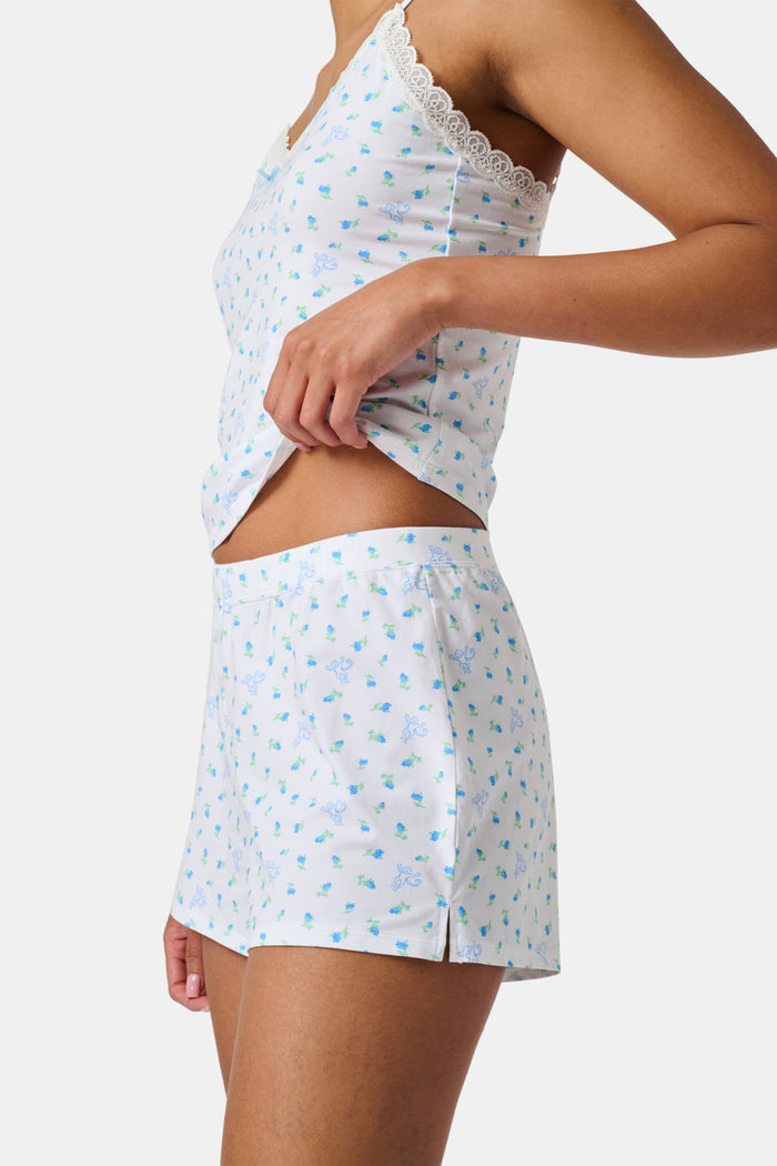 Introducing the Roller Rabbit Mini Monkey Blossom Jones Shortie, a white boxer short featuring a playful pattern of small blue and green turtles and rabbits. Crafted from soft cotton modal for a gentle feel and relaxed fit, this short is showcased against a simple light background.