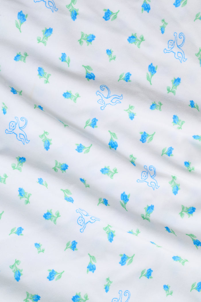 Introducing the Roller Rabbit Mini Monkey Blossom Jones Shortie, a white boxer short featuring a playful pattern of small blue and green turtles and rabbits. Crafted from soft cotton modal for a gentle feel and relaxed fit, this short is showcased against a simple light background.