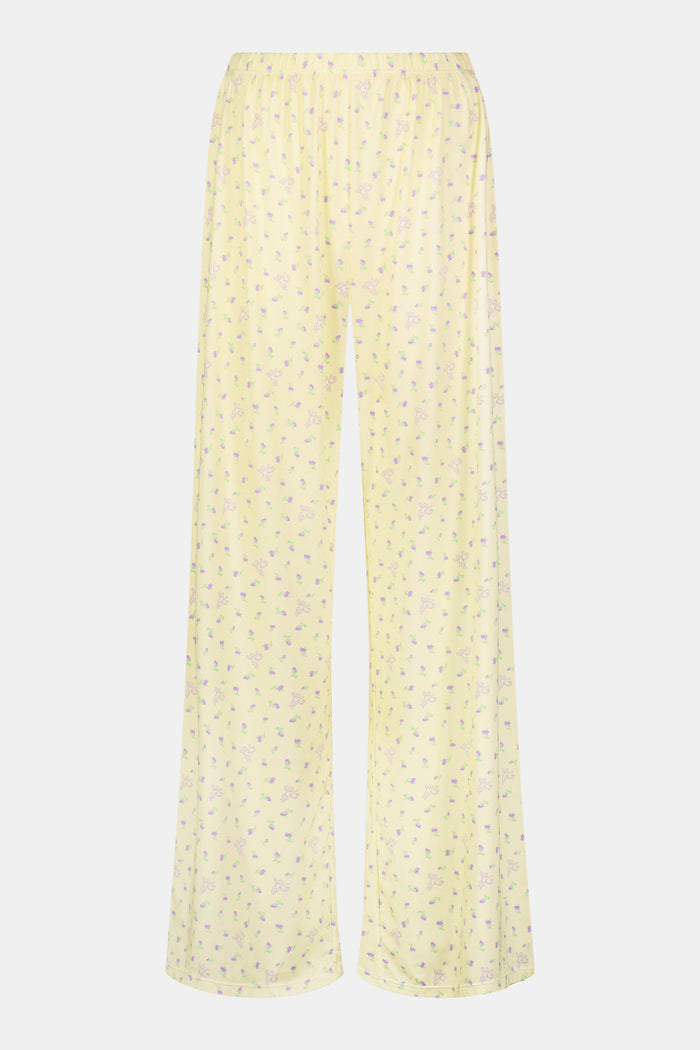 Yellow wide-leg pajama pants with a small yellow floral print pattern, crafted from a soft cotton modal blend, shown on a white background. These comfortable Roller Rabbit Mini Monkey Blossom Monroe Pants are perfect for relaxing at home.