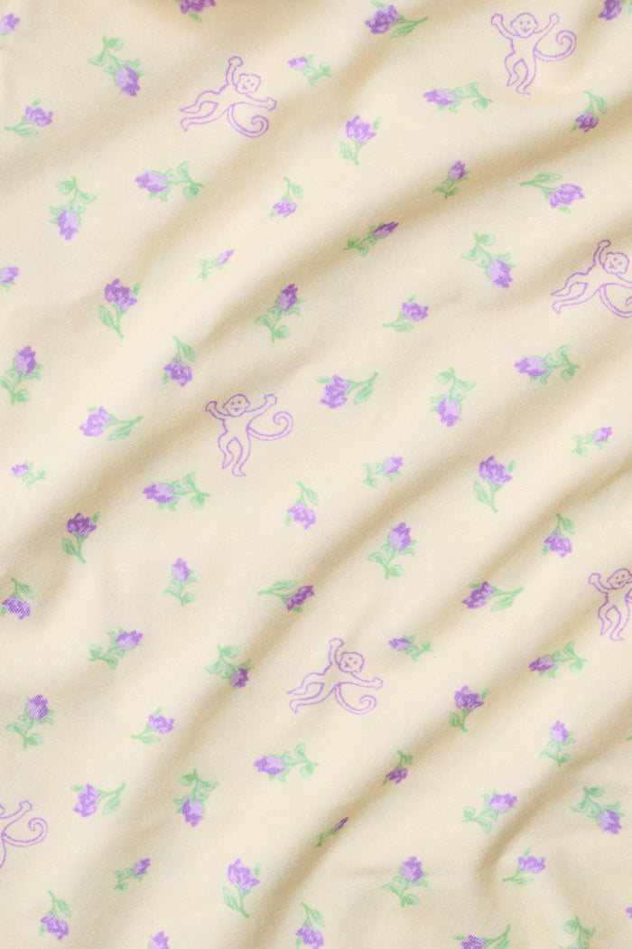 Yellow wide-leg pajama pants with a small yellow floral print pattern, crafted from a soft cotton modal blend, shown on a white background. These comfortable Roller Rabbit Mini Monkey Blossom Monroe Pants are perfect for relaxing at home.