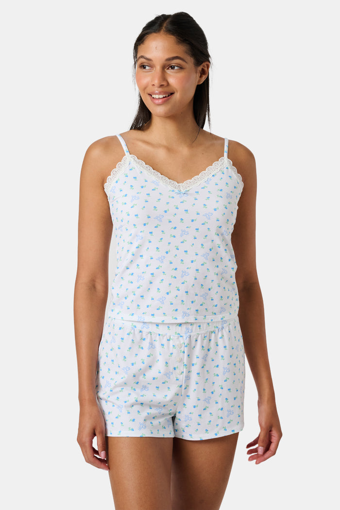 Mini Monkey Blossom Perry Cami by Roller Rabbit, featuring a blue floral print with delicate lace trim at the neckline and thin adjustable shoulder straps, crafted from a soft cotton-modal blend, displayed on a plain light background.