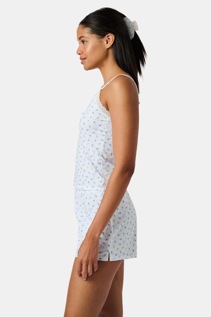 Mini Monkey Blossom Perry Cami by Roller Rabbit, featuring a blue floral print with delicate lace trim at the neckline and thin adjustable shoulder straps, crafted from a soft cotton-modal blend, displayed on a plain light background.