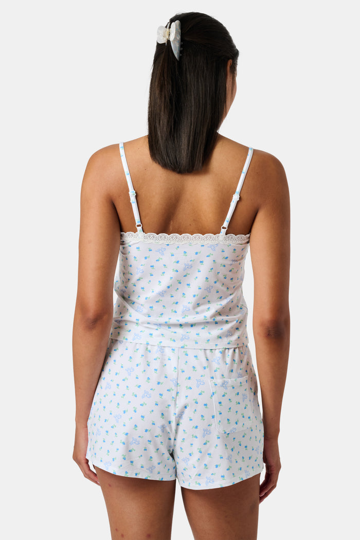 Mini Monkey Blossom Perry Cami by Roller Rabbit, featuring a blue floral print with delicate lace trim at the neckline and thin adjustable shoulder straps, crafted from a soft cotton-modal blend, displayed on a plain light background.