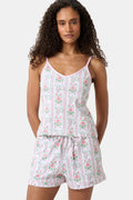 A woman with long curly hair wears the Roller Rabbit Monkey Block Stripe Mischa Set: a two-piece loungewear set featuring a matching camisole and shorts. She stands against a plain light background.