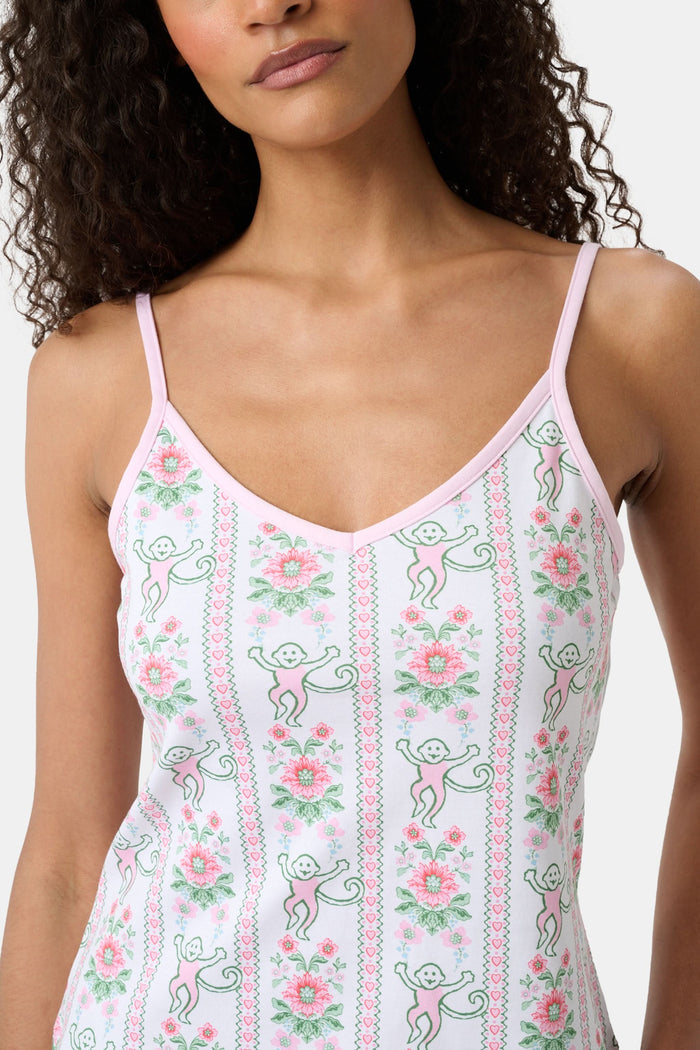 A woman with long curly hair wears the Roller Rabbit Monkey Block Stripe Mischa Set: a two-piece loungewear set featuring a matching camisole and shorts. She stands against a plain light background.