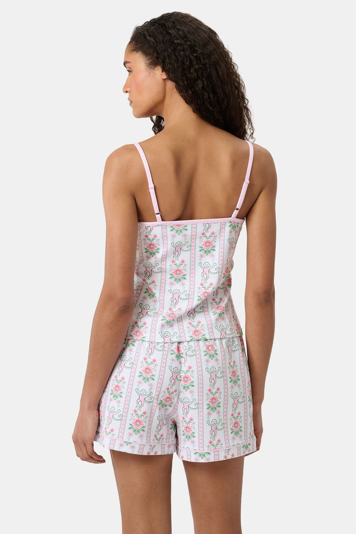 A woman with long curly hair wears the Roller Rabbit Monkey Block Stripe Mischa Set: a two-piece loungewear set featuring a matching camisole and shorts. She stands against a plain light background.