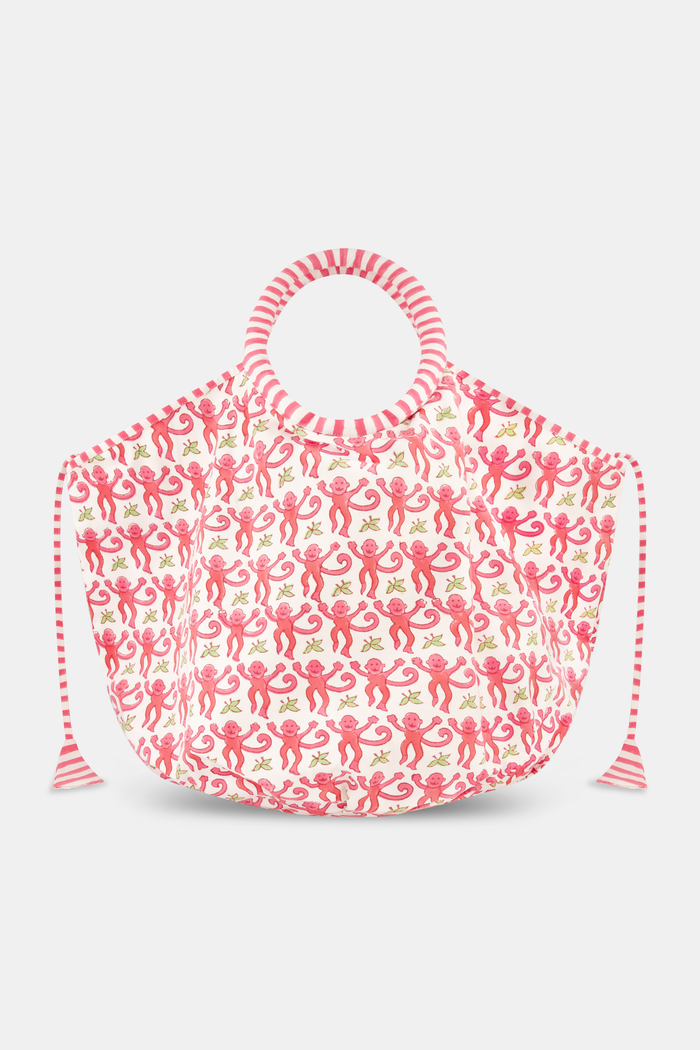 The SAPPHIRE Monkey Bondi Bag is a spacious cotton canvas tote with a playful pink monkey pattern, pink striped handles, and drawstring ties.