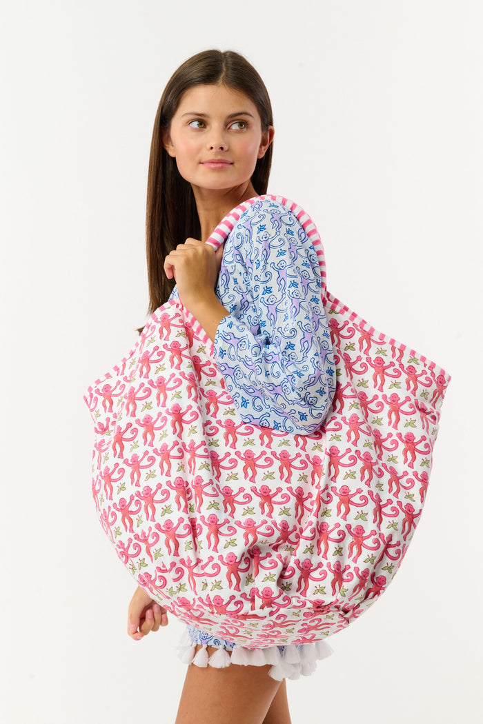 The SAPPHIRE Monkey Bondi Bag is a spacious cotton canvas tote with a playful pink monkey pattern, pink striped handles, and drawstring ties.