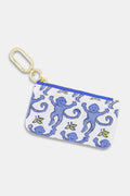 The Roller Rabbit Monkey Coin Pouch is a small cotton canvas zippered pouch with a blue monkey print on white, water-resistant lining, gold key clip, and blue zipper.