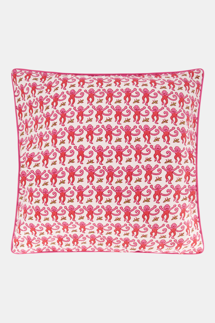 The Roller Rabbit Monkey Decorative Pillow features a white cotton cover with playful pink monkey patterns and is accented with pink piping for a charming finish.