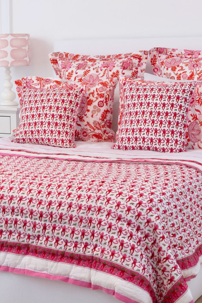 The Roller Rabbit Monkey Decorative Pillow features a white cotton cover with playful pink monkey patterns and is accented with pink piping for a charming finish.