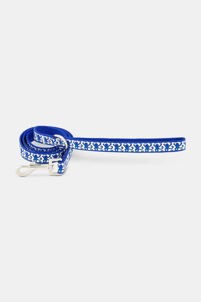 The Roller Rabbit Monkey Dog Leash is a blue printed polyester leash with a metal clip, shown neatly coiled on a white background. Matching collar available.