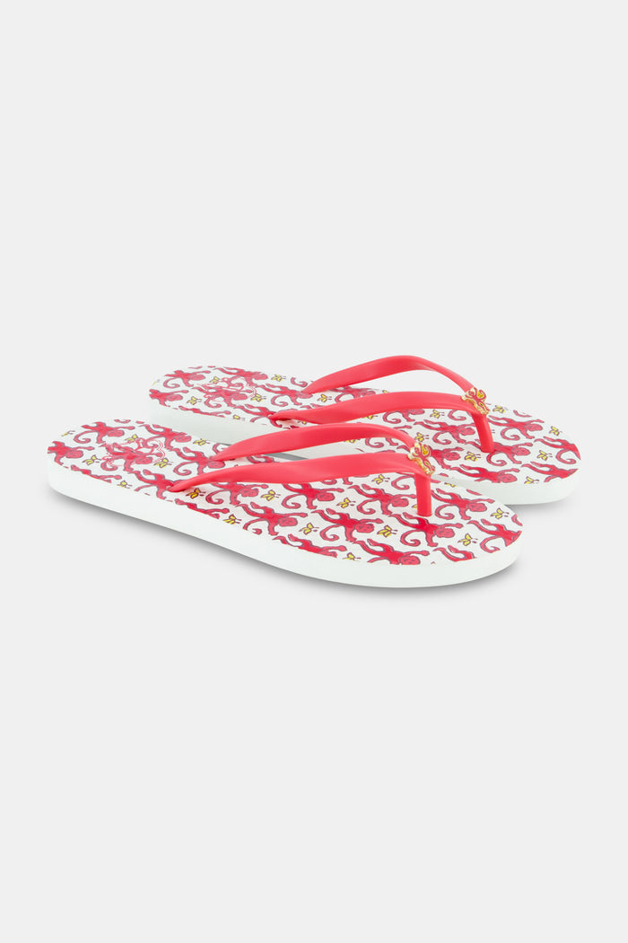 The Roller Rabbit Monkey Flip Flop is a women's beach sandal with pink straps and a colorful, swirling pink and red footbed design, shown side by side on a white background.