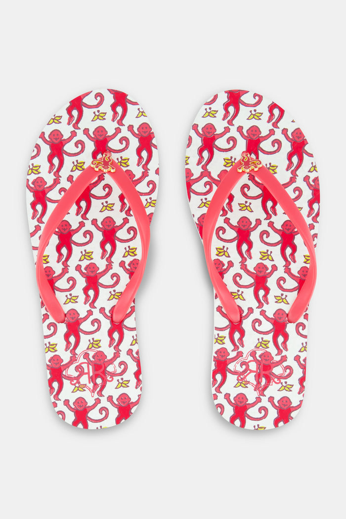 The Roller Rabbit Monkey Flip Flop is a women's beach sandal with pink straps and a colorful, swirling pink and red footbed design, shown side by side on a white background.