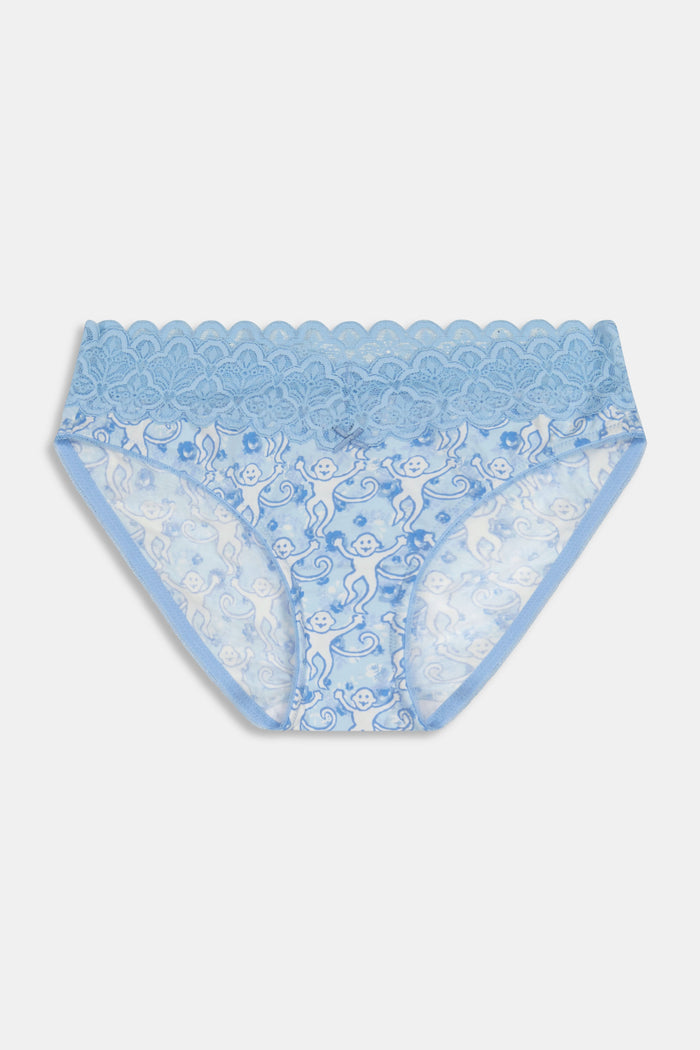 A woman wears the Roller Rabbit Monkey Rosette Waverly Bikini, a matching super-soft modal bra and panties set with lace trim and a delicate swirl pattern, shown from mid-thigh to shoulders against a plain background.