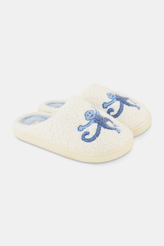 The Roller Rabbit Monkey Star Fuzzy Slipper features cozy blue fuzz, a light blue lining, cute embroidered monkey designs on top, and a durable rubber sole.