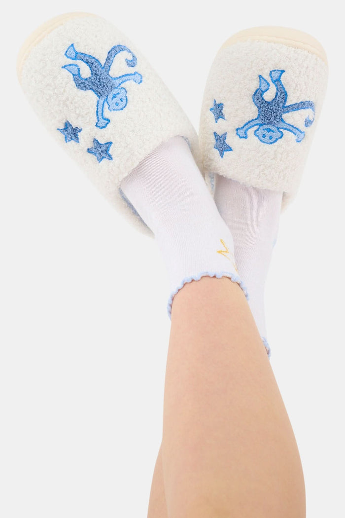 The Roller Rabbit Monkey Star Fuzzy Slipper features cozy blue fuzz, a light blue lining, cute embroidered monkey designs on top, and a durable rubber sole.
