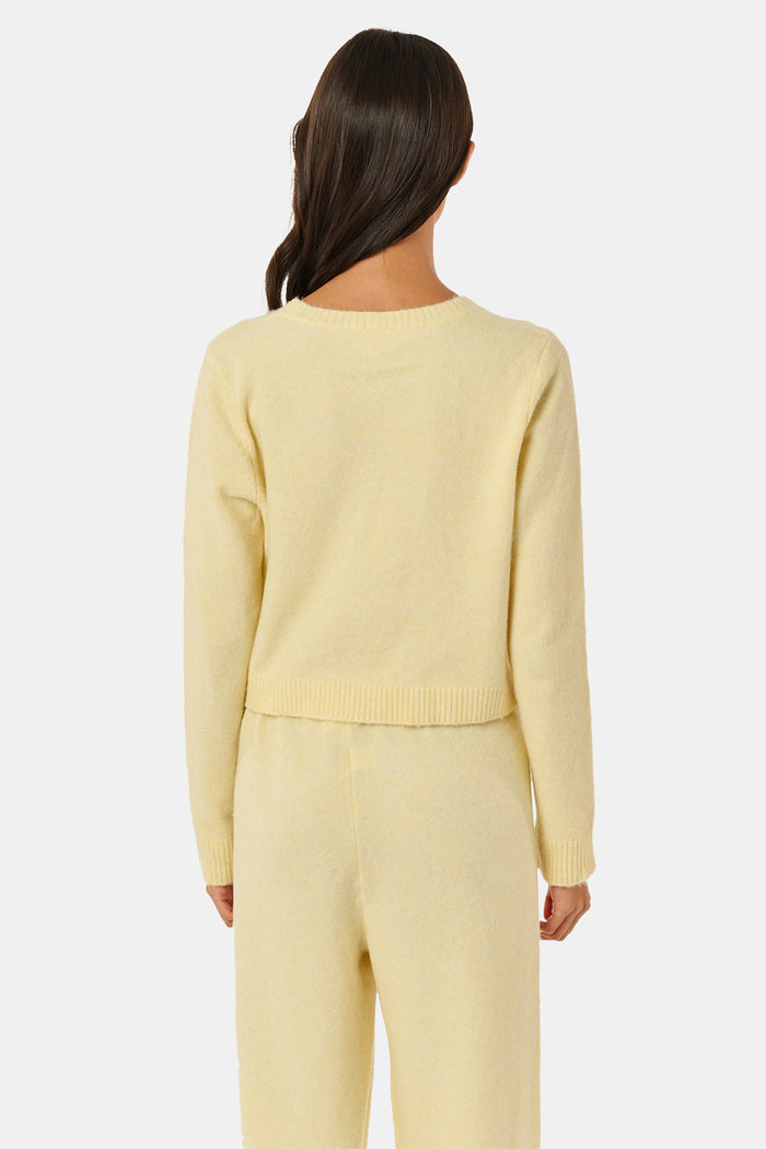 A woman wearing the Roller Rabbit Moxie Cardigan in butter yellow with matching pants, standing against a plain white background.