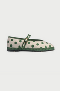 The FLABELUS Polka Dot Pierre is a cream Mary Jane flat with green polka dots, a green sole, and a green strap with a gold buckle, shown side view on a plain white background.