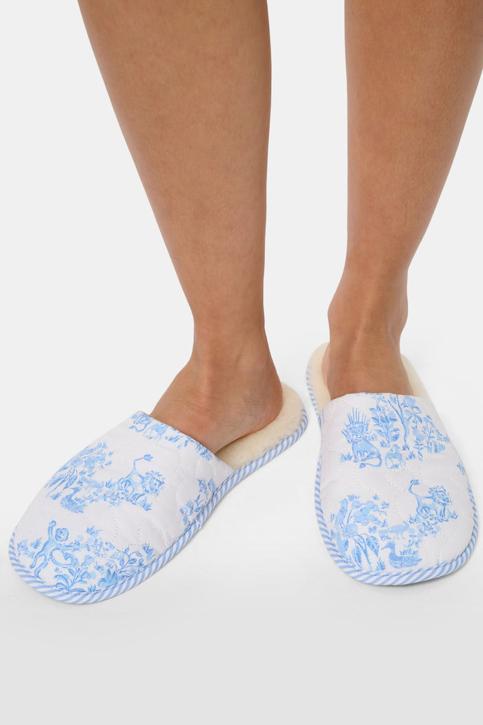 The Roller Rabbit Sherwood Forest Monkey Quilted Slipper, featuring a blue and white toile pattern and faux-shearling lining, is displayed on a plain white background.
