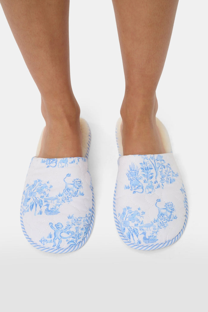 The Roller Rabbit Sherwood Forest Monkey Quilted Slipper, featuring a blue and white toile pattern and faux-shearling lining, is displayed on a plain white background.
