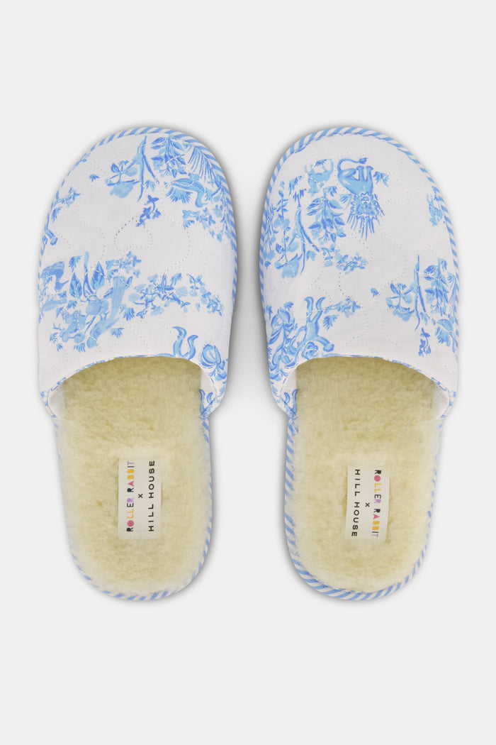 The Roller Rabbit Sherwood Forest Monkey Quilted Slipper, featuring a blue and white toile pattern and faux-shearling lining, is displayed on a plain white background.