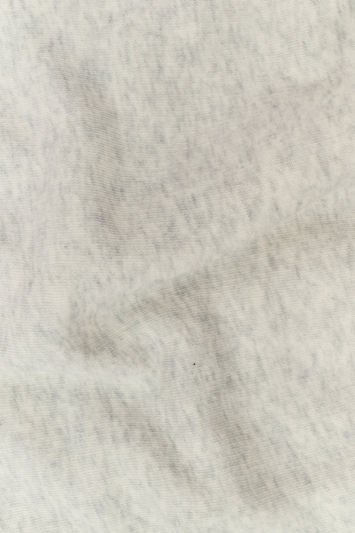 A person with long blonde hair wears the Roller Rabbit Sleep Club Lola Hoodie and wide leg sweatpants in light gray Dream Fleece, standing with hands in the hoodie pockets against a plain white background.