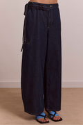 Dark blue wide-leg jeans on a beige background